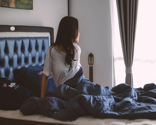 woman practicing yoga at home in soft morning light